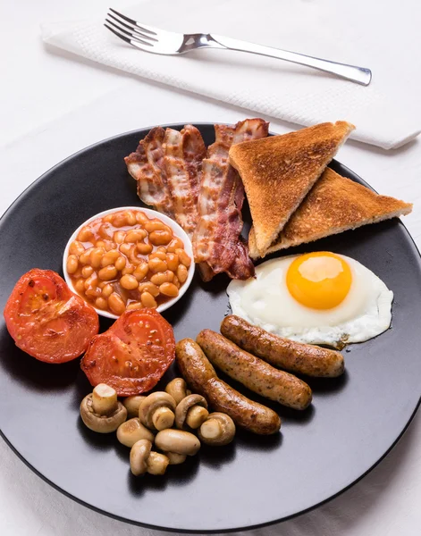 Englisches Frühstück auf schwarzem Teller — Stockfoto