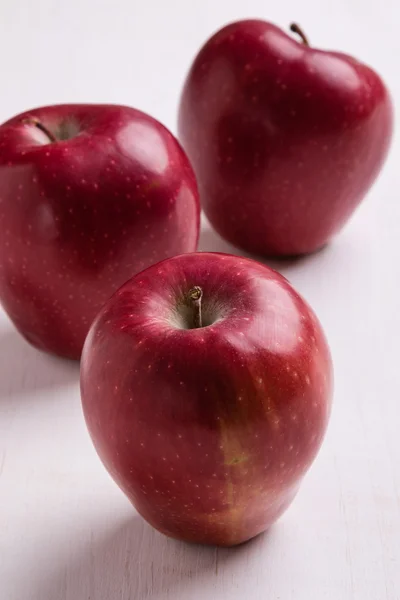 Red apple on white table — Stock Photo, Image