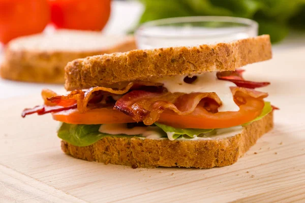 bacon sandwich on wooden table
