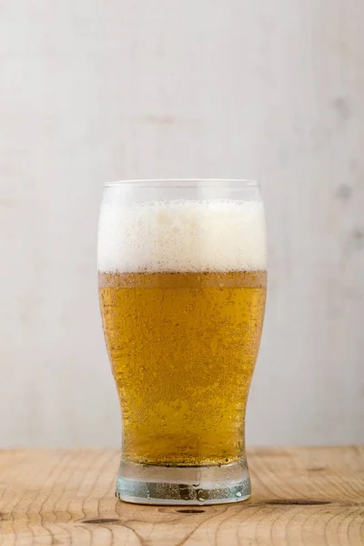 Beer on wooden table — Stock Photo, Image