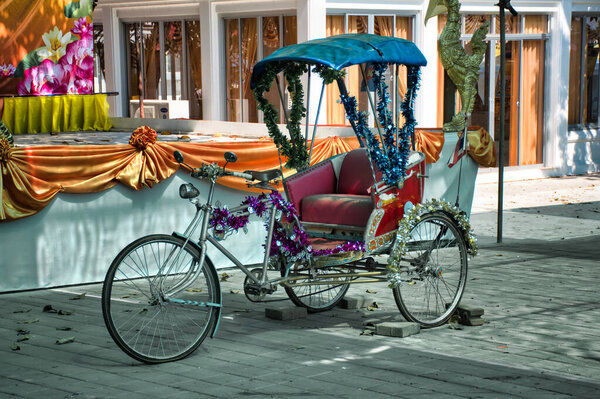 Ko Kret, Thailand 01.04.2020: Thai style vintage retro tricycle bike or rickshaw decorated and exhibited on a street market at Koh Kret island