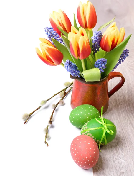 Easter border with spring flowers and Easter eggs isolated on white, space for your text on the right