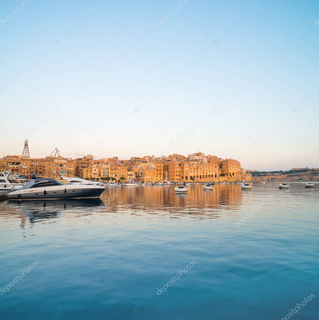 Sailing boats on Senglea marina in Grand Bay, Valetta, Malta, on a bright sunny morning, panoramic image