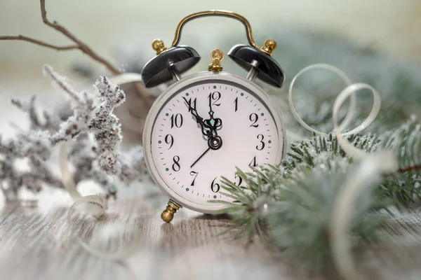 Old alarm clock showing five to midnight. Happy New Year!