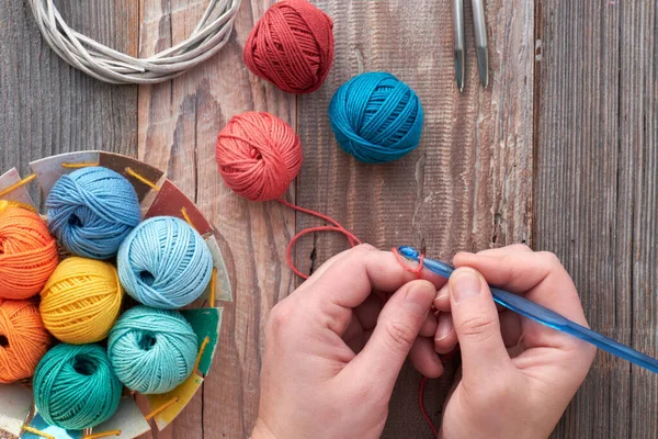 Crochet, top view on hand with Crochet hook and yarn balls, top — стокове фото