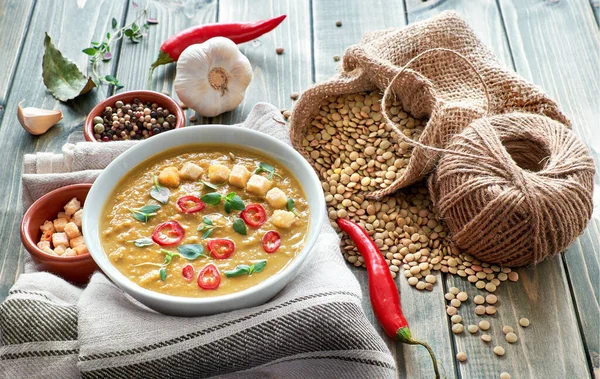 Spicy lentil soup with chili, garlic and thyme on rustic wooden — Stock Image Spicy lentil soup with chili, garlic and thyme on rustic wooden Royalty Free Stock Photos