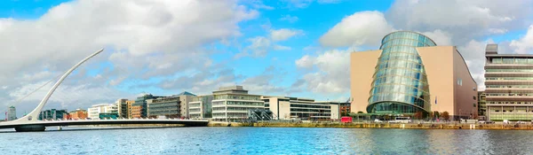 Trendy Dublin riverside. Panoramic image of Convention Centre and Samuel Beckett Bridge over the river Liffey in refurbished docklands area known as Grand Canal Harbor.