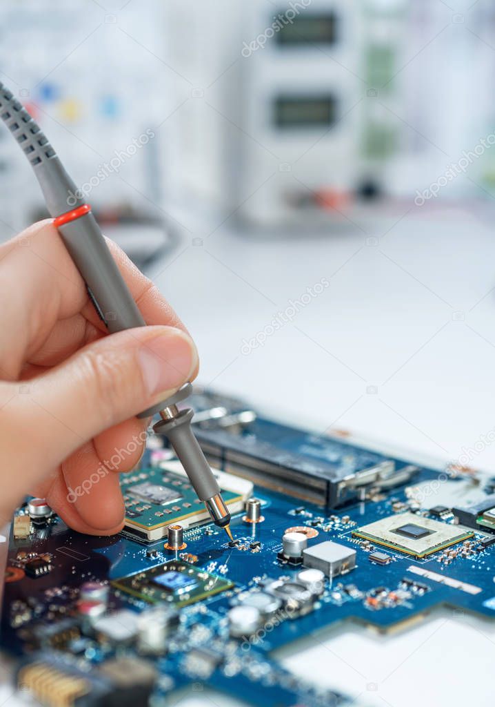 Electronics repair service, hand of female tech fixes an electronic circuit, text space
