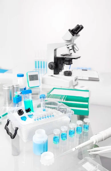 Scientific background with samples, pipette, and ice basket