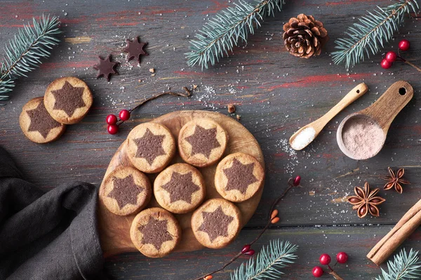 Biscoitos de Natal com padrão de estrela de chocolate em uma mesa com co — Fotografia de Stock