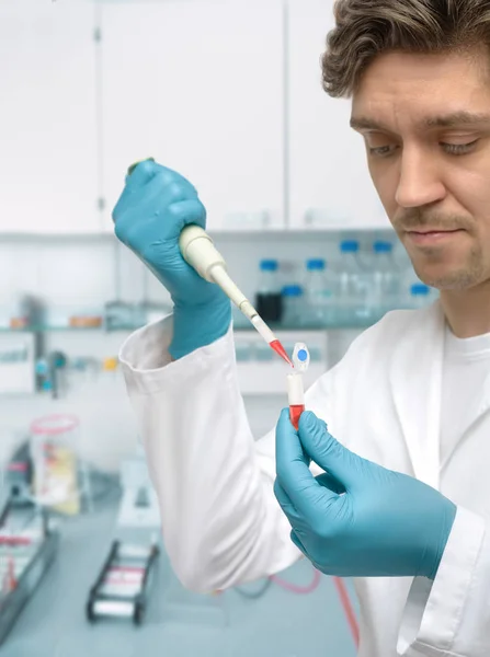 Young male scientist or graduate student with pipette — 스톡 사진
