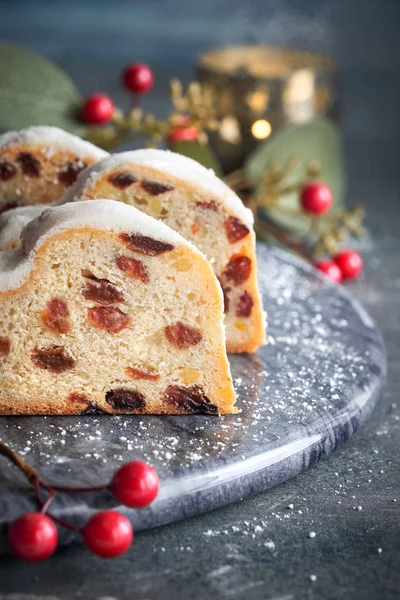 Natal stollen on dark festive background with candle, berrie — Stok Foto