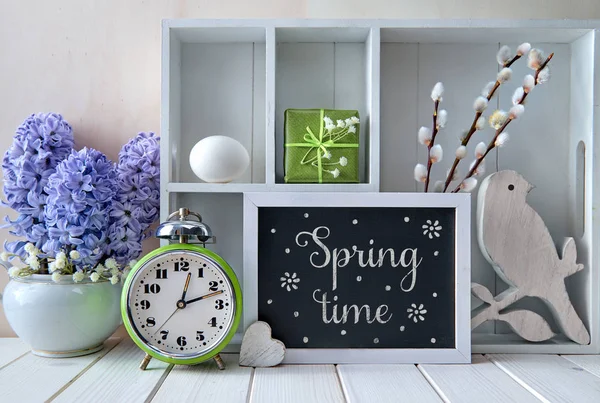 Old alarm clock, blue hyacinth flowers and a display cabinet wit — 스톡 사진