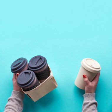 Çeşitli bambu yolculukları yeniden kullanılabilir kahve, çay fincanları ya da nane yeşili arka planda silikon yalıtımlı şarjörler. Elinde birkaç kupa var. Düşük etkili yaşam tarzı için çevre dostu sıfır atık çözümü.
