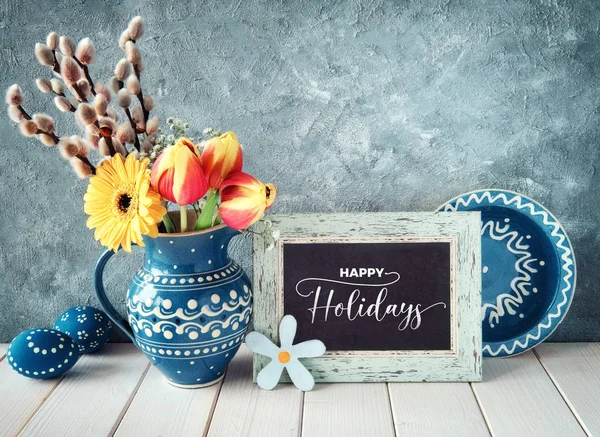 Spring flowers in classic blue color ceramic pitcher with matchi