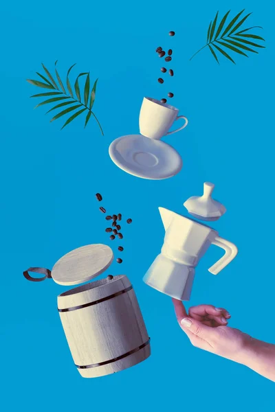 Trendy levitation. Flying line of coffee beans between ceramic coffee maker and espresso cup with saucer. Blue mint background with natural palm leaves. — 图库照片