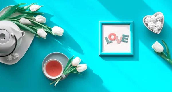 Spring geometric flat lay. Female hand hold frame with text You are special. Tea cup, pot, sweets and white tulips on turquoise. Mothers day, international women day 8 March or your Mom birthday. — 스톡 사진