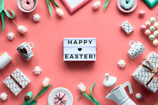 Geometric Easter flat lay in white and green on pink background. Plastic lightboard with text \