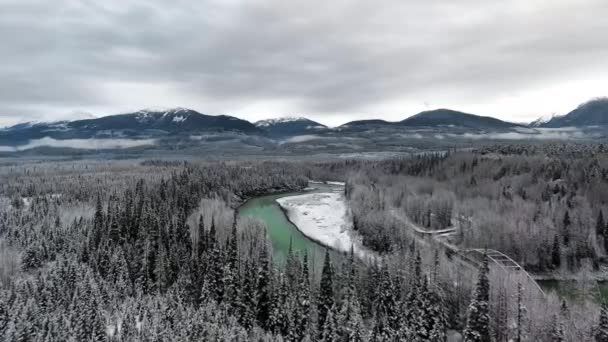 Drone Camera Moves Thick Snowy Forest Emerald Pond Highway Mountains — Stock Video