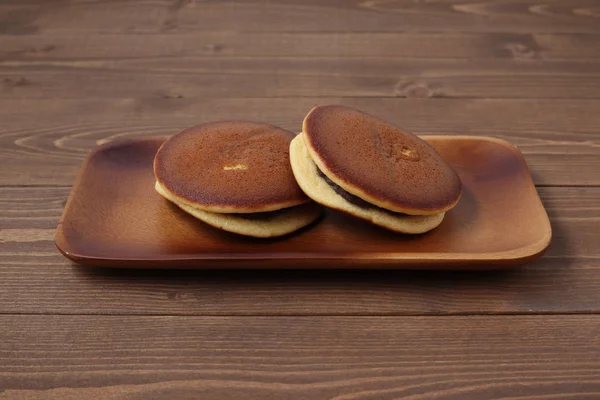 dorayaki japanese traditional pancake isolated on wooden table