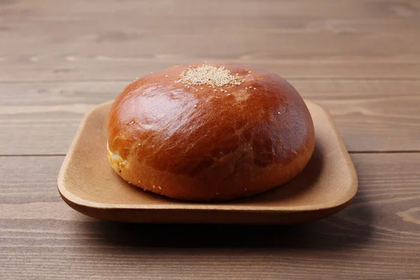 Anpan pão redondo com azuki feijão vermelho colar isolado na placa na mesa de madeira — Fotografia de Stock