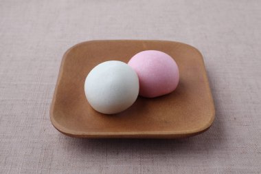 kouhaku manjyu Japanese traditional confectionery cake wagashi on plate isolated on table cloth
