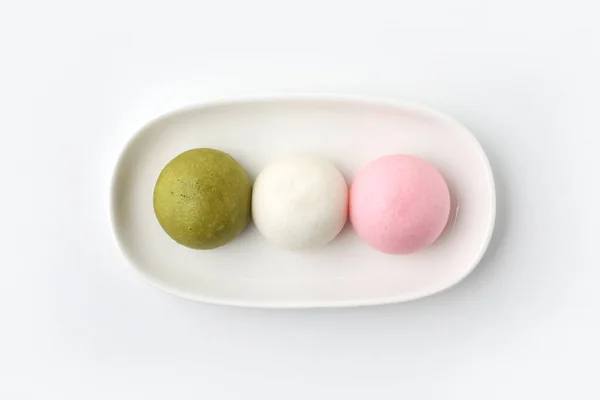 Tricolor manjyu Japanese traditional confectionery cake wagashi on plate isolated on white background — Zdjęcie stockowe