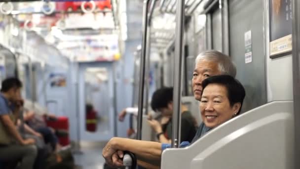 Asian Senior travel backpack in Japanese train for holiday — Stock Video