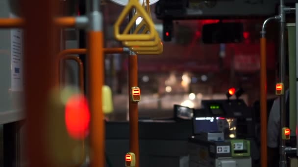 View of handle inside the night city bus. Abstract public transportation in Asia. — Stock Video
