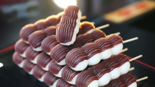 Japanese traditional dessert Dango, sweet mocha rice ball with red bean paste on top — Stock Video