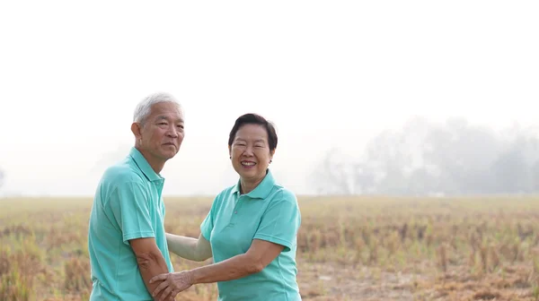 Potrait of Asian senior couple on bright green background — Stock Photo, Image