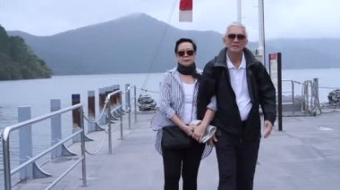 Birlikte göl cruise gemi iskelede yürüyüş şık Asya son sınıf öğrencisi. Birlikte dünyayı dolaşarak