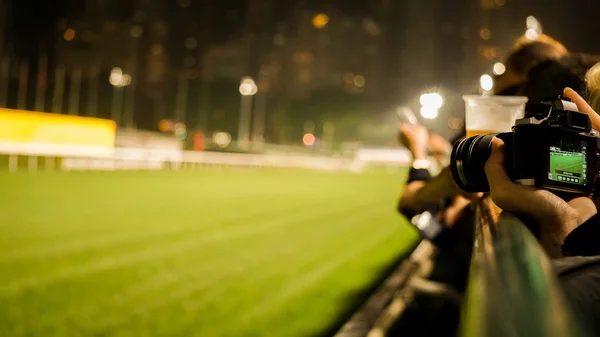 Crowd at horse race course edge cheering, taking photo and prepa — Stock Photo, Image