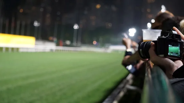 Crowd at horse race course edge cheering, taking photo and prepa — Stock Photo, Image