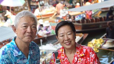 Asian senior couple having fun retirment trip around the world clipart