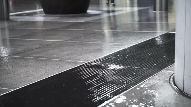 Asian pedestrians walking through rain in business district area on wet floor — Αρχείο Βίντεο