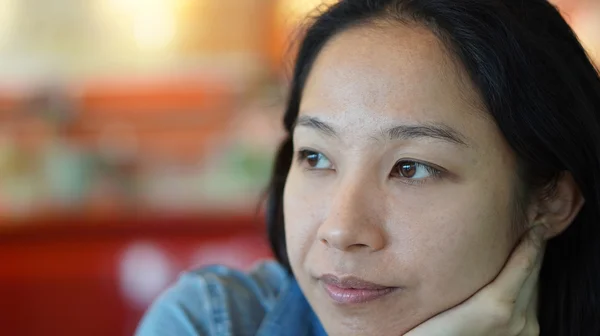 Mixed race Asian woman looking away, thinking and smiling — Stock Photo, Image