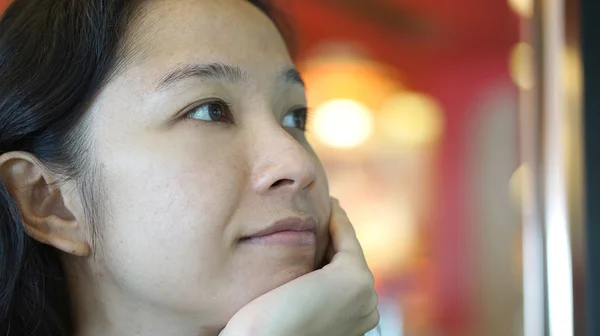 Mixed race Asian woman looking away, thinking and smiling — Stock Photo, Image