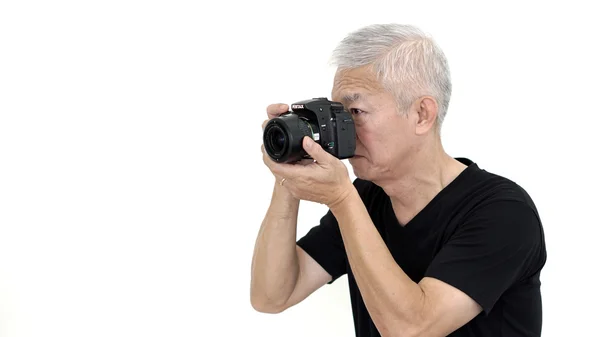 Asian senior man professional photographer taking photo on white isolate background — Stock Photo, Image