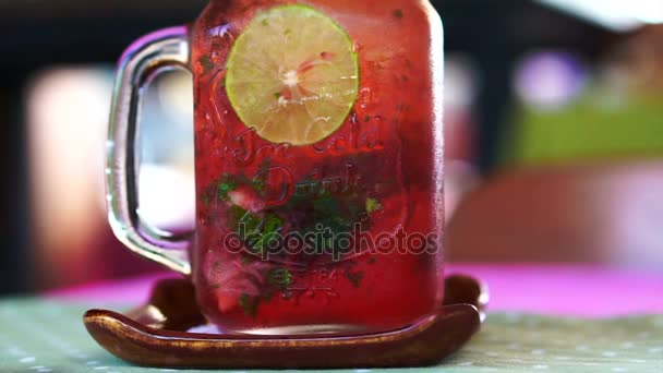 Fresh summer drink red strawberry, lemon and mint serve in mason jar — Stock Video