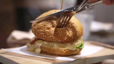 Bıçak ve çatal kesme bun ve sığır eti burger kullanarak ele