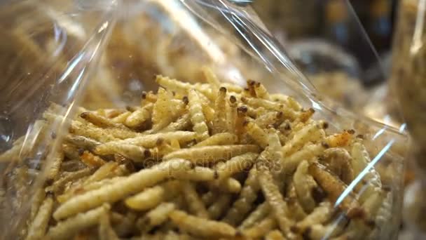 Gebakken bamboe wormen verpakt in Thaise lokale markt. Rare insecten eten van Thailand — Stockvideo