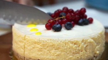 Bıçak kesim bütün İngiliz lirası-in cheesecake üstüne çilek ile