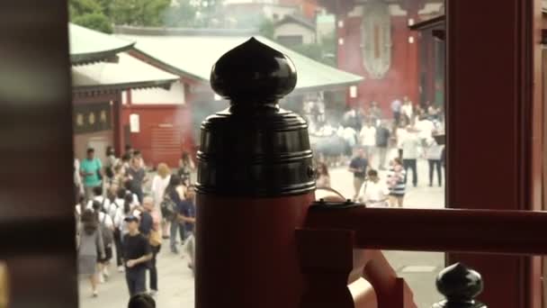 Tokyo, Japan - September 2016: Senso-ji Temple in Asakusa area. Crowd and people lit incese and praying  under good luck smoke — Stock Video