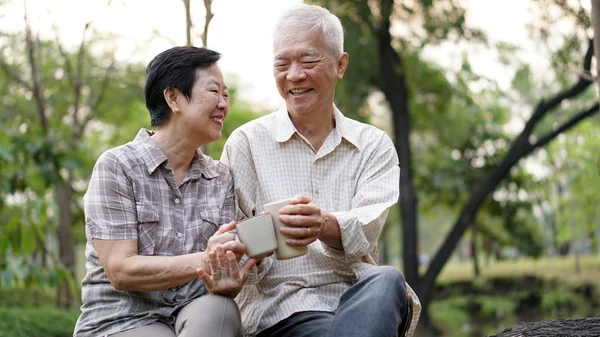 Start day with morning coffee, Asian senior retired couple sitting in green copy space — Stock Photo, Image