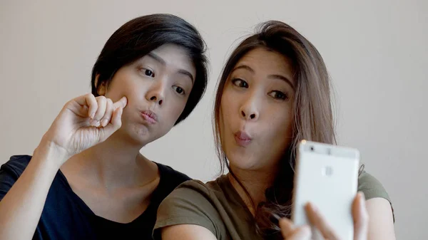 Due ragazze asiatiche di razza mista scattare selfie con smart phone — Foto Stock