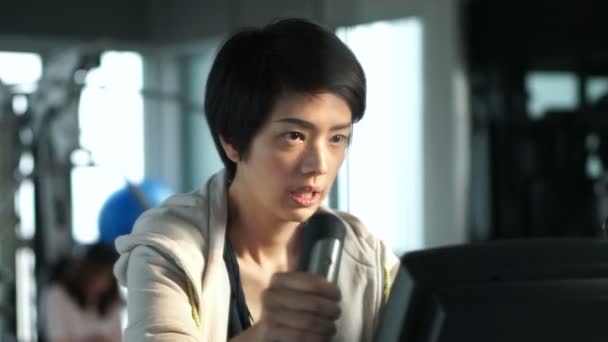 Asian Short Hair Athlete Girl Cycling Gym Bicycle At Fitness To
