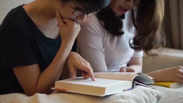 Twee Aziatische vrouw vrienden hebben vrije tijd lezen van boeken en het doen van discussie — Stockvideo