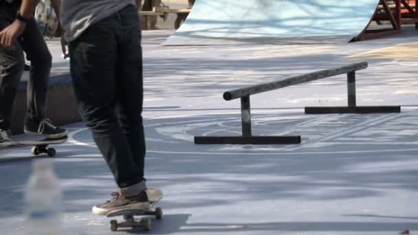 Um homem jogando skate truque no chão de concreto em câmera lenta — Vídeo de Stock