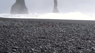 4 k siyah kumlu lav beach Vik, İzlanda. Düşük açılı, tilt Simgesel Yapı sahil yakınında bazalt deniz yığınları yukarı